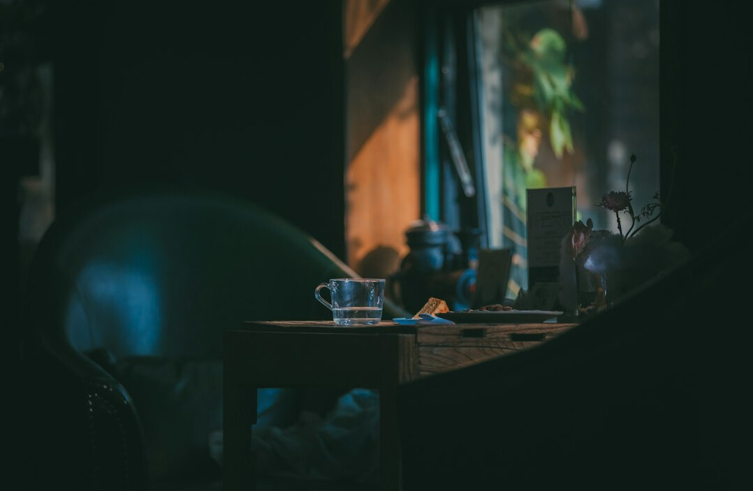 Investigative journalist's desk with documents and laptop at night